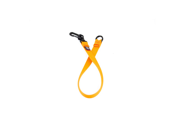 An 16-inch Zest (orange) Key Strap with a snaphook at one end and an o-ring at the other.